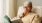 a man sitting on a couch reading